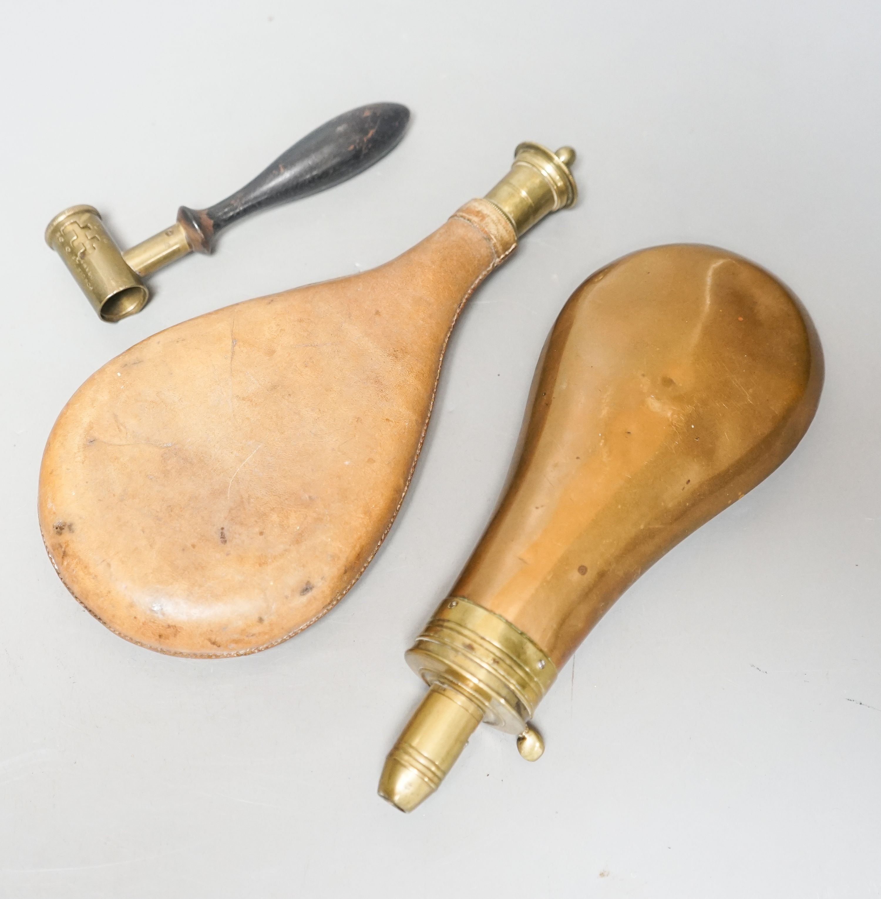 Two 19th century shot flasks and a powder measure